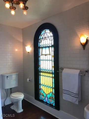 a bathroom with a toilet sink and mirror