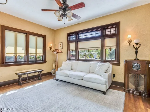 a living room with furniture and a floor to ceiling window