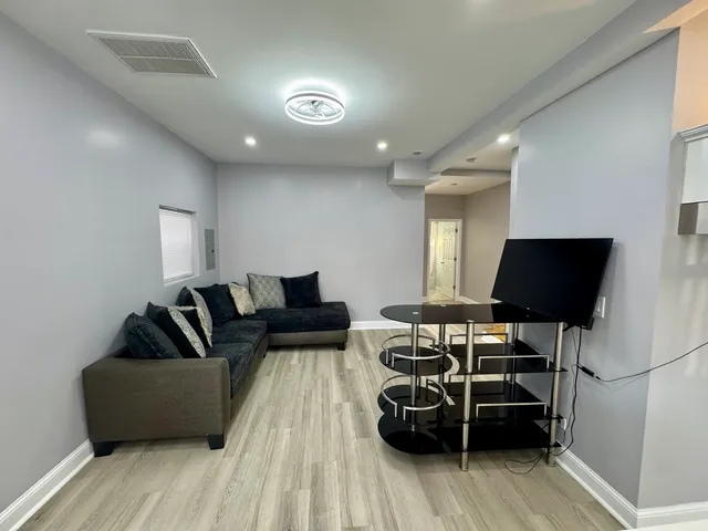 a bathroom with a double vanity sink mirror and toilet