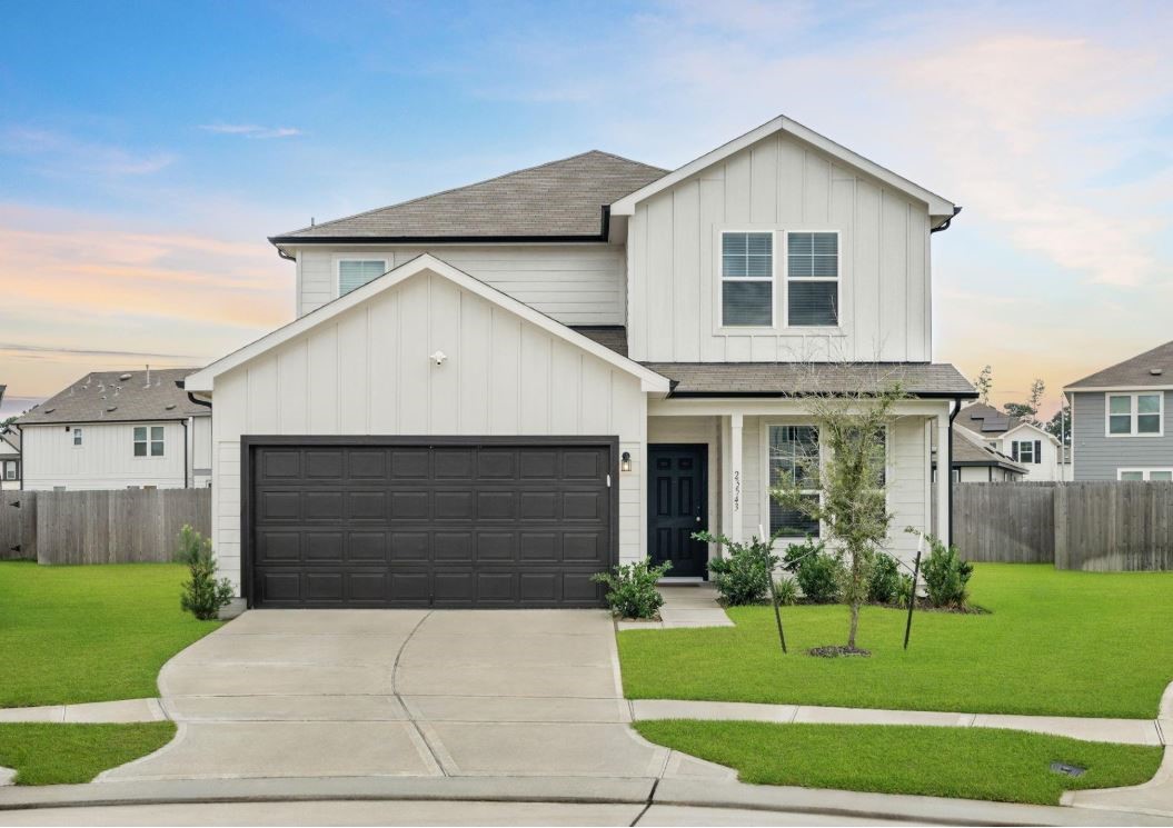 a front view of a house with a yard and garage