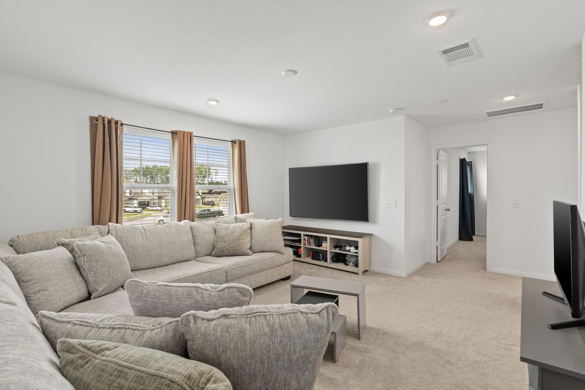 23543 Powmill Street Spring, TX 77373 - Photo 6 of 11 a living room with furniture and a flat screen tv