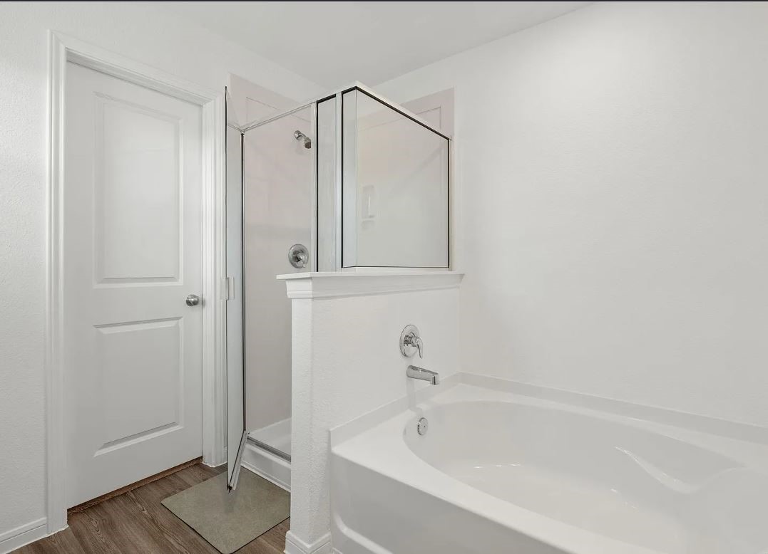 23543 Powmill Street Spring, TX 77373 - Photo 9 of 11 a bathroom with a bathtub and a shower