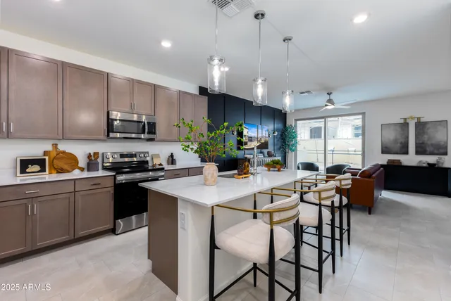 a kitchen with a table chairs microwave and cabinets