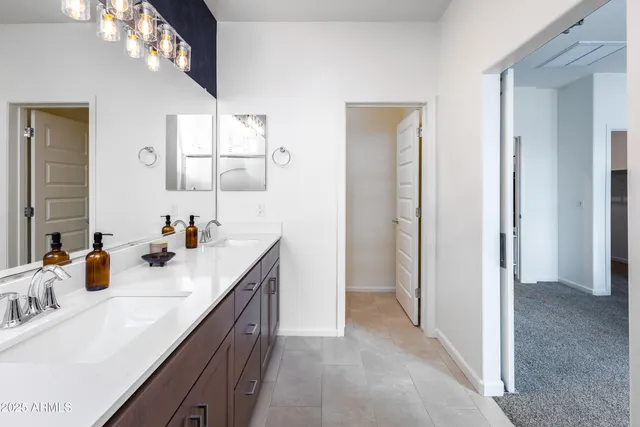 a bathroom with a sink vanity and mirror
