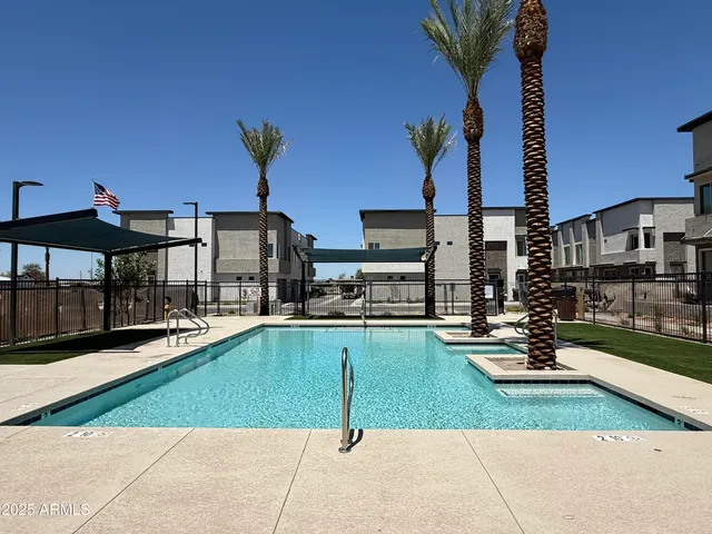 a swimming pool with outdoor seating and yard