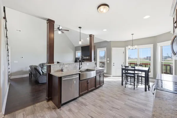 a large kitchen with a table and chairs