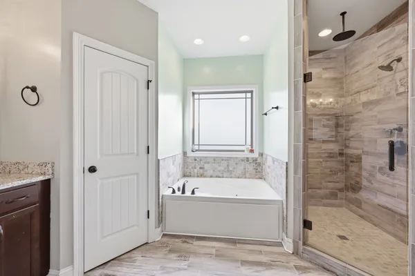 a bathroom with a bathtub and a shower