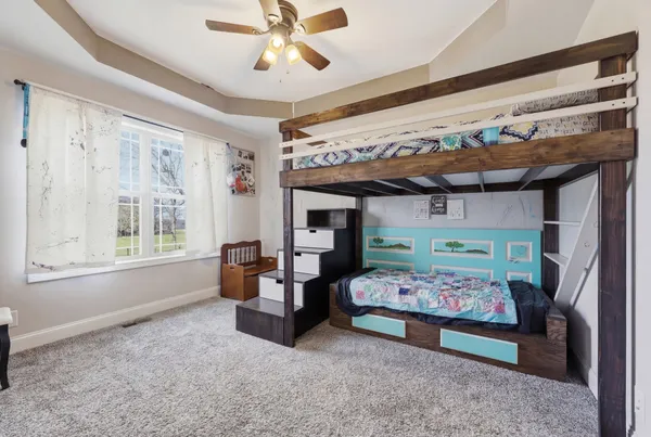 a bedroom with furniture and a large window