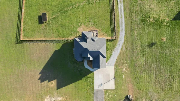 an aerial view of a house with a yard
