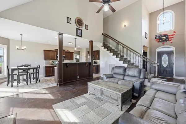 a living room with furniture a fireplace and a chandelier