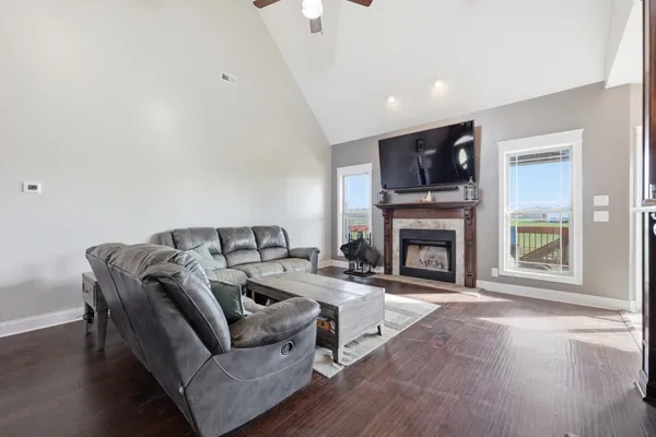 a living room with furniture a fireplace and a flat screen tv