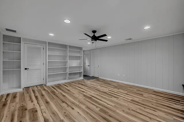 a view of a livingroom with a ceiling fan and wooden floor