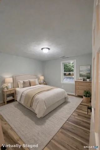 a bedroom with a large bed and a view of kitchen