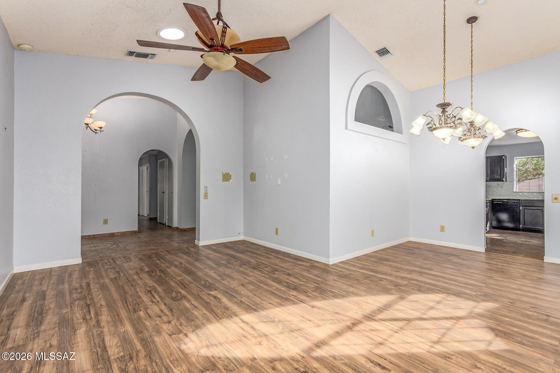 5331 West Eaglestone Loop Tucson, AZ 85742 - Photo 9 of 35 a view of a livingroom with a chandelier fan and wooden floor