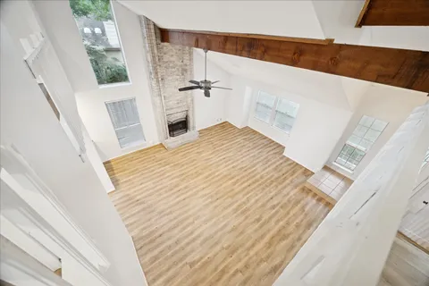 a view of a bedroom with wooden floor and staircase