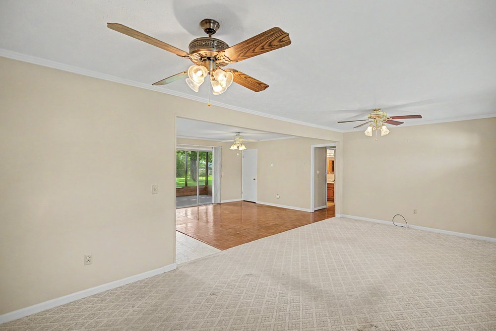 115 Brunson Drive Pickens, SC 29671 - Photo 10 of 29 A comfortable living space featuring plush carpeting, rich hardwood flooring, and direct access to an enclosed porch.