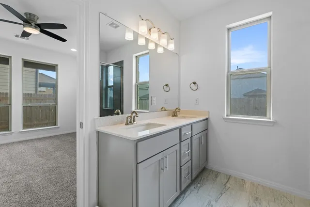 a bathroom with a sink a light fixture and a mirror