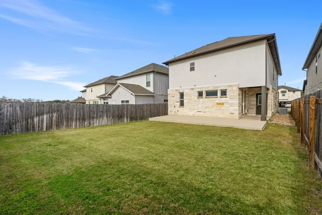 a view of a house with backyard and garden