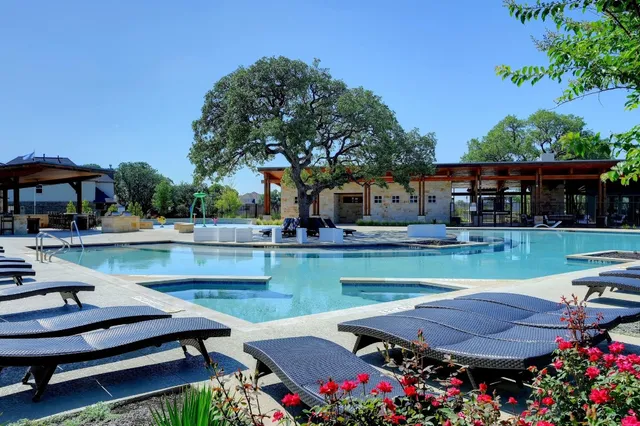 a view of swimming pool with outdoor seating and a patio