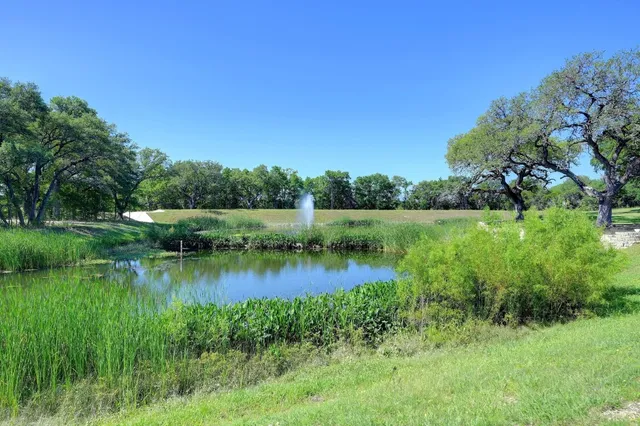 a view of a lake with a house in the background
