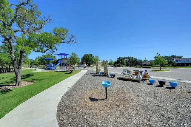 a view of a park with lots of swings and slides