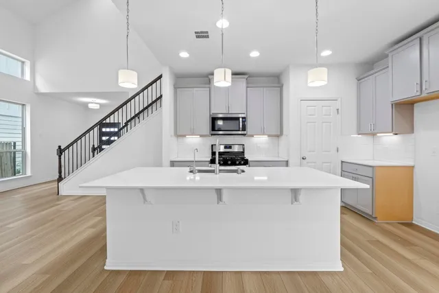 a kitchen with kitchen island white cabinets and white appliances