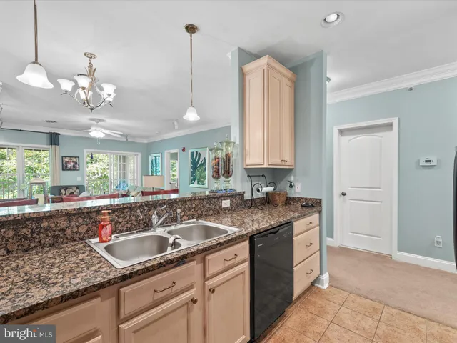 a kitchen with granite countertop stainless steel appliances a sink stove and cabinets