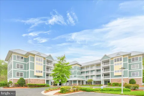 a view of a tall building next to a yard