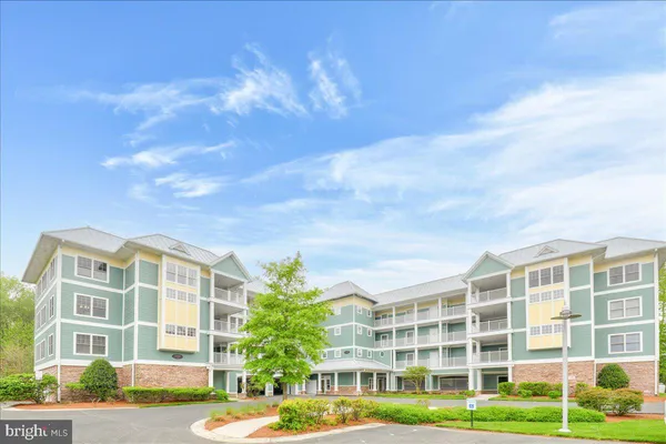 a view of a tall building next to a yard
