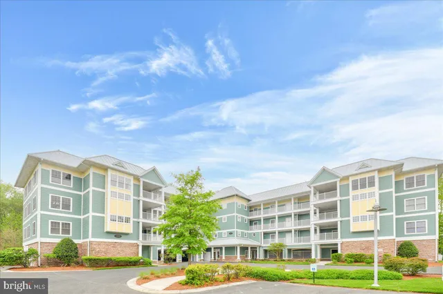 a view of a tall building next to a yard