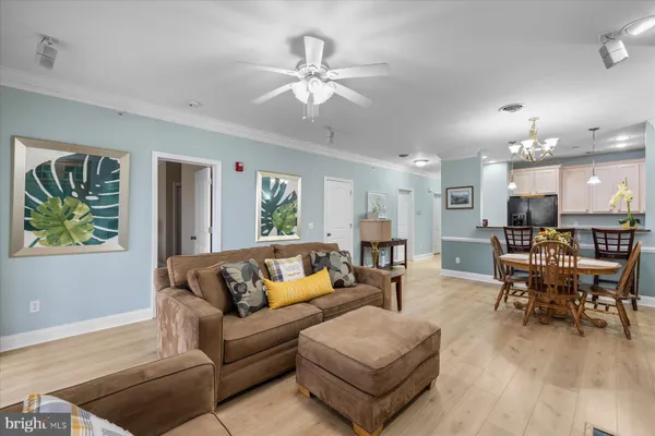 a living room with furniture and a chandelier