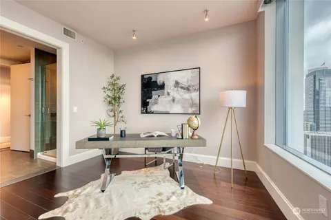 a bedroom with a bed and wooden floor