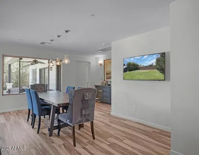 a view of a dining room with furniture and wooden floor
