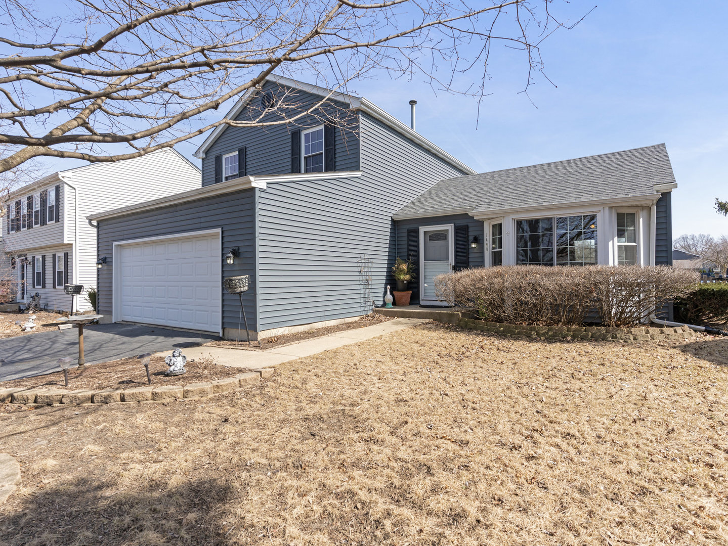 1400 Bar Harbour Road Aurora, IL 60504 - Photo 1 of 25 a front view of a house with a yard and garage