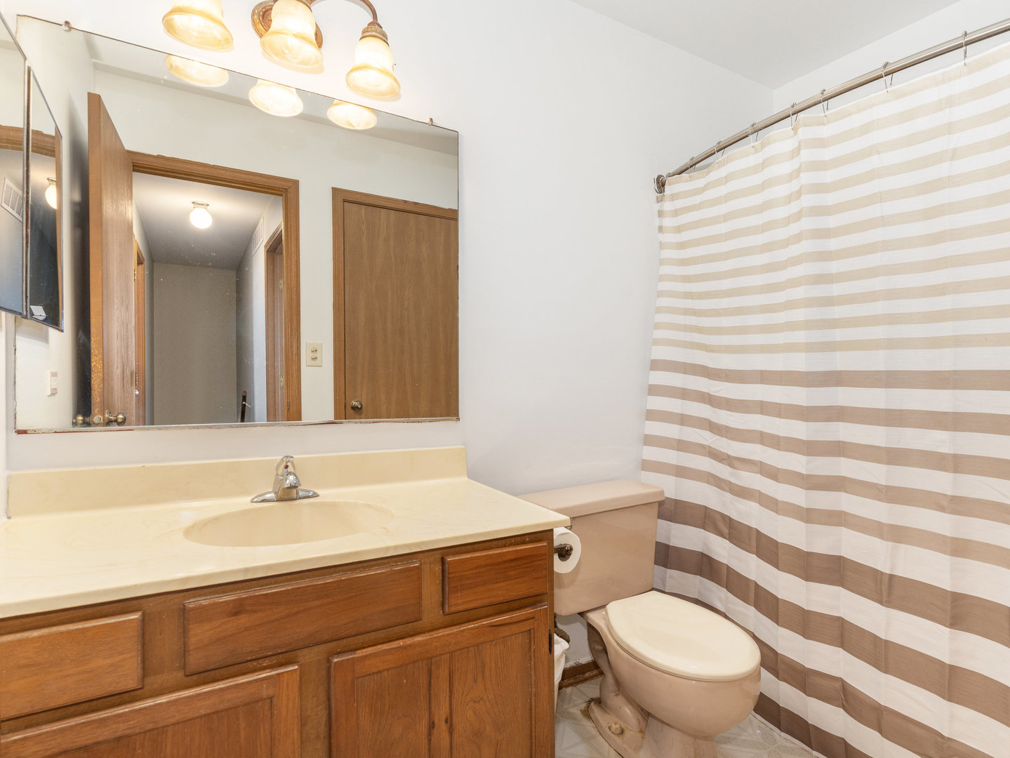 1400 Bar Harbour Road Aurora, IL 60504 - Photo 13 of 25 a bathroom with a sink a toilet a mirror and shower curtain
