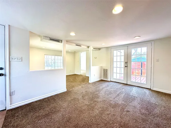 an empty room with windows and closet