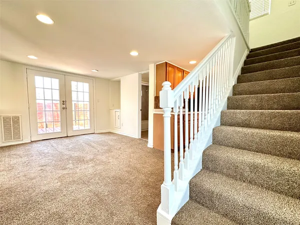 a view of an empty room with stairs