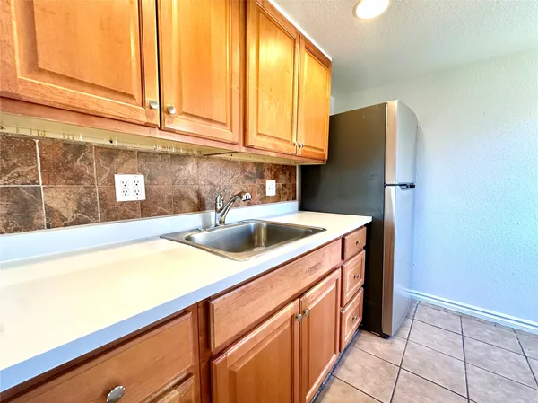 a kitchen with stainless steel appliances a sink and a refrigerator
