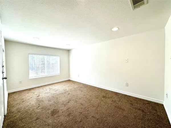an empty room with a empty space and a window