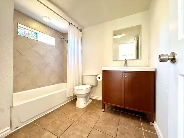 a bathroom with a toilet a sink and bathtub