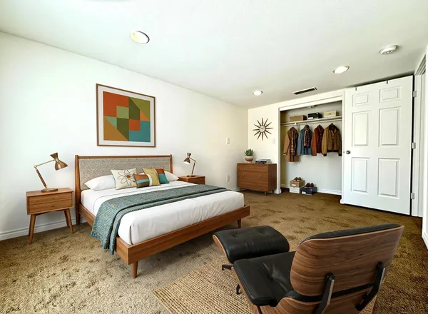 a bedroom with a bed and a couch