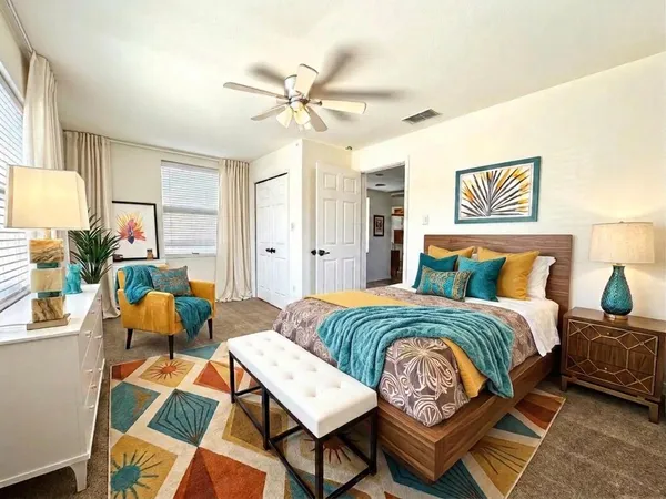 a bedroom with a bed and a chandelier