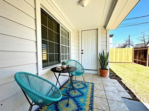 a view of balcony with two chairs and a potted plant