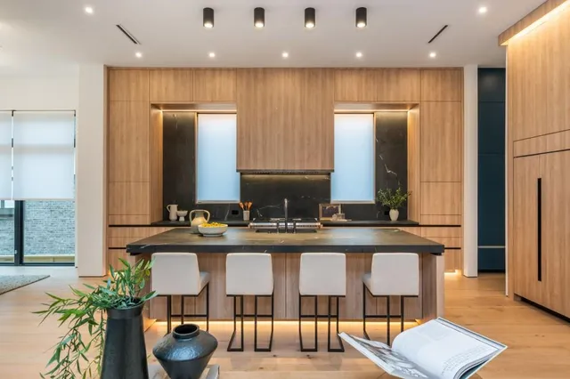 a kitchen with granite countertop lots of wooden cabinets a sink and dishwasher