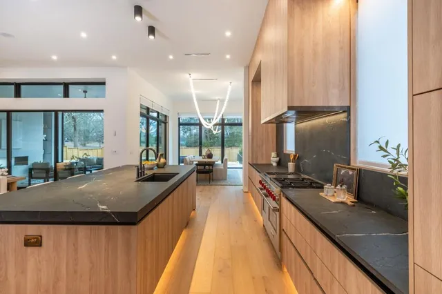 a kitchen with counter top space a sink and appliances