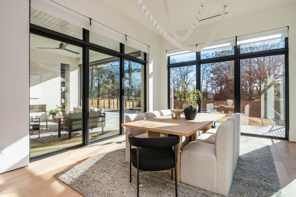 1127 Wimberly Road Northeast Atlanta, GA 30319 - Photo 19 of 37 a view of a dining room with furniture large windows and wooden floor