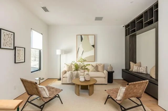 a living room with furniture and wooden floor