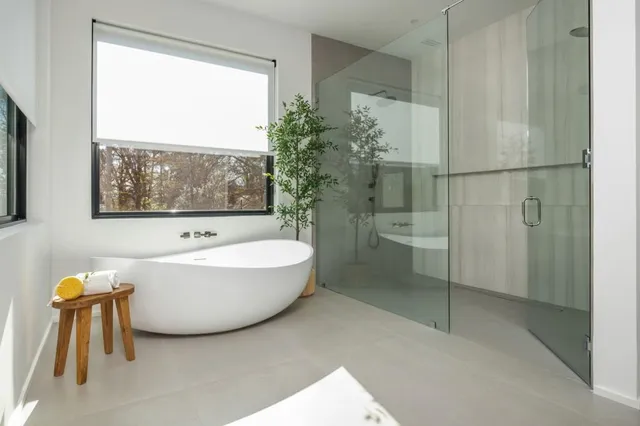 a bathroom with a bathtub and a shower