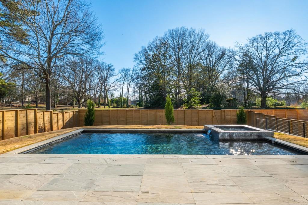 1127 Wimberly Road Northeast Atlanta, GA 30319 - Photo 34 of 37 a view of swimming pool with trees and wooden fence