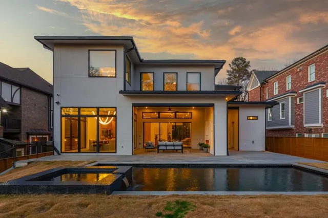 a view of a house with swimming pool and sitting area